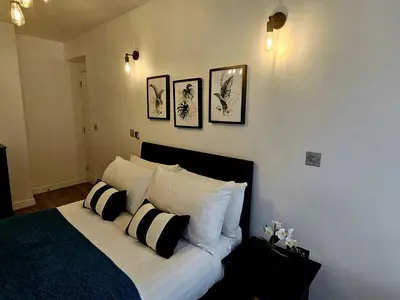 a bedroom with a bed with black and white pillows at Falkner Square in Liverpool