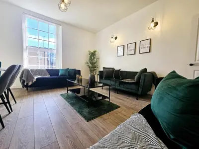 a living room with a couch and a table at Falkner Square in Liverpool