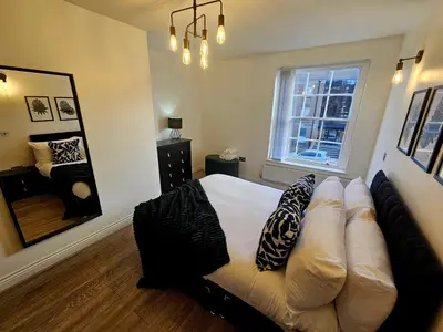 a bedroom with a bed and a large mirror at Falkner Square in Liverpool