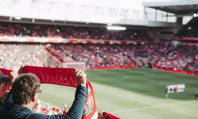 a crowd of people at a soccer stadium at Anfield House in Liverpool