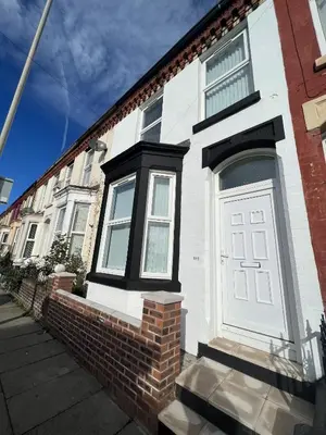 a house with a white door and a brick wall at Anfield House in Liverpool