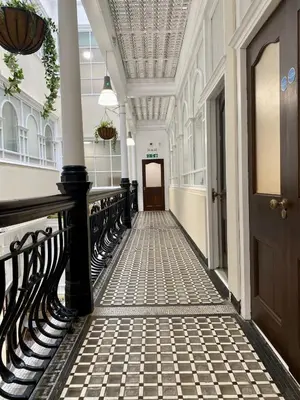 a hallway with a black railing and a door at Lennon Place in Liverpool
