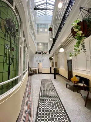 a hallway in a building with a glass ceiling at Lennon Place in Liverpool