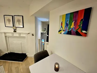a living room with a painting on the wall at Lennon Place in Liverpool