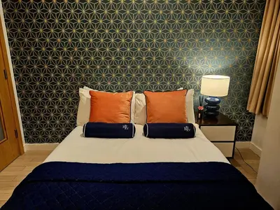 a bedroom with a bed with orange pillows at McCartney Place at the Cavern Quarter in Liverpool