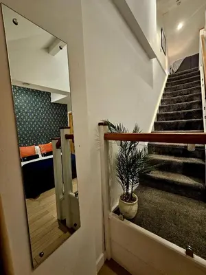 a stairway with a potted plant and a mirror at McCartney Place at the Cavern Quarter in Liverpool