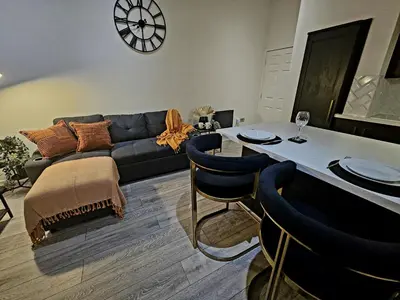 a living room with a couch and a table with chairs at Rodney Street in Liverpool