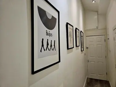 a hallway with framed pictures on a wall at Rodney Street in Liverpool