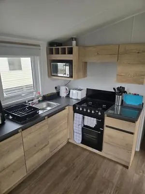 a kitchen with a stove and a sink at 8 berth Caravan in Morecambe