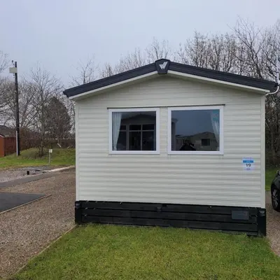 a house with a window on the side of it at 8 berth Caravan in Morecambe