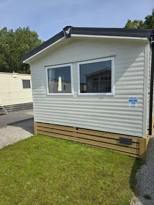 a house with a window on the side of it at 8 berth Caravan in Morecambe