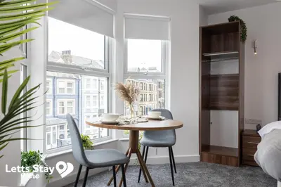 a dining room with a table and two chairs at Eden Bay Serviced Apartments - Eden in Morecambe