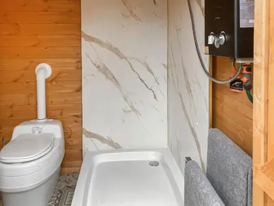 a small bathroom with a toilet and a sink at Sunset Cabin in Ormskirk