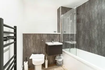 a bathroom with a toilet and a sink and a shower at Spacious & Bright 1 Bed Apartment in Liverpool in Liverpool