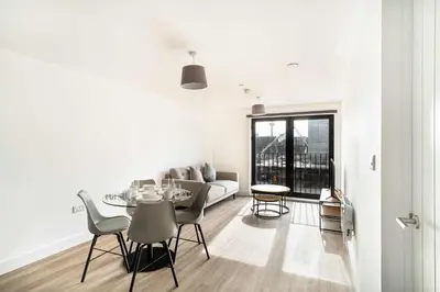 a living room with a table and a couch at Spacious & Bright 1 Bed Apartment in Liverpool in Liverpool