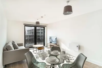 a living room with a table and a couch at Spacious & Bright 1 Bed Apartment in Liverpool in Liverpool
