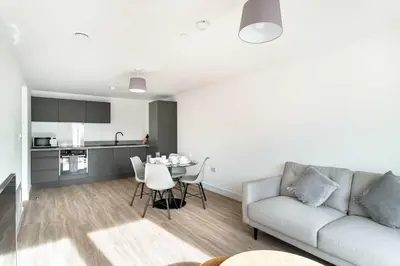 a living room with a couch and a table at Spacious & Bright 1 Bed Apartment in Liverpool in Liverpool