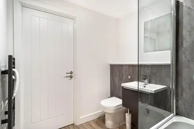 a white bathroom with a toilet and a sink at Spacious & Bright 2 Bed Apartment in Liverpool in Liverpool