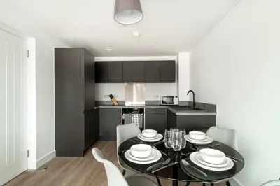 a kitchen with a dining room table and chairs at Spacious & Bright 2 Bed Apartment in Liverpool in Liverpool