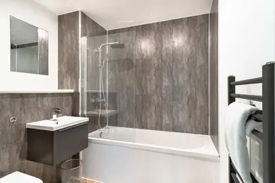 a bathroom with a tub and a sink and a shower at Spacious & Bright 2 Bed Apartment in Liverpool in Liverpool