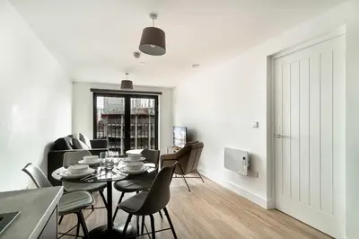 a dining room with a table and chairs at Spacious & Bright 2 Bed Apartment in Liverpool in Liverpool