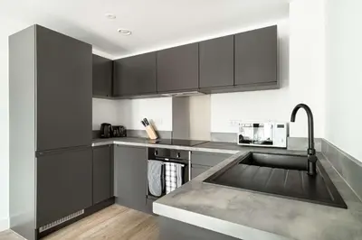 a kitchen with gray cabinets and a sink at Spacious & Bright 2 Bed Apartment in Liverpool in Liverpool