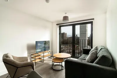 a living room with a couch and a table at Stunning 2 Bedroom Apartment in Liverpool w Views in Liverpool