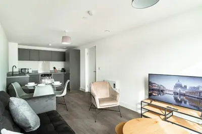 a living room with a couch and a dining room at Stunning 2 Bedroom Apartment in Liverpool w Views in Liverpool
