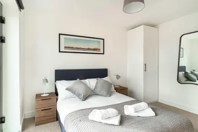 a bedroom with a bed with two towels on it at Stunning 2 Bedroom Apartment in Liverpool w Views in Liverpool