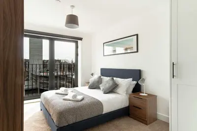 a bedroom with a bed and a large window at Stunning 2 Bedroom Apartment in Liverpool w Views in Liverpool