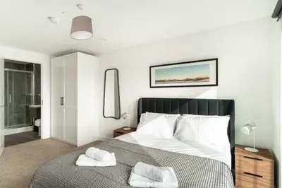 a bedroom with a bed with two towels on it at Stunning 2 Bedroom Apartment in Liverpool w Views in Liverpool