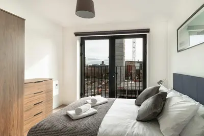 a bedroom with a bed with a large window at Stunning 2 Bedroom Apartment in Liverpool w Views in Liverpool