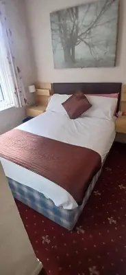 a large bed in a bedroom with at Balin Helmshore in Blackpool