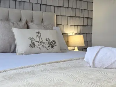 a bedroom with a white bed with two pillows on it at #18 Anfield 5 min walk Sleeps 7 4BR 5Bed 3Bathrms in Liverpool