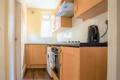 a kitchen with a stove and a dishwasher at Travellers Economic Stays in Orrell Park in Liverpool