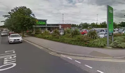 a car driving down a road in a parking lot at Travellers Economic Stays in Orrell Park in Liverpool