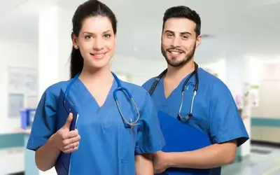 two doctors wearing blue scrubs in a hospital at Travellers Economic Stays in Orrell Park in Liverpool