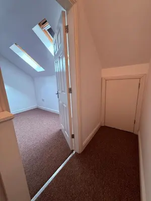 an attic room with a closet and a door at Beautiful park view town house in Wigan