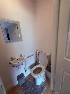 a bathroom with a toilet and a sink at Beautiful park view town house in Wigan