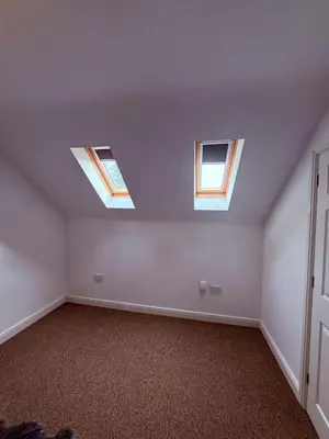 an empty room with three skylights in the ceiling at Beautiful park view town house in Wigan