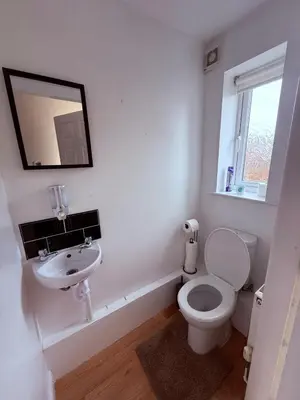 a white bathroom with a toilet and a sink at Beautiful park view town house in Wigan