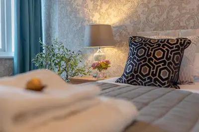 a bedroom with a bed with a pillow and a lamp at Southport Rabbit Retreat in Southport