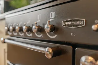 a close up of a stove with a bunch of knobs at Southport Rabbit Retreat in Southport