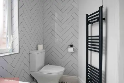 a bathroom with a toilet and a wall at Apartment near Blackpool Central & Pleasure Beach in Blackpool