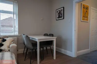 a white table and chairs in a room with a window at Apartment near Blackpool Central & Pleasure Beach in Blackpool
