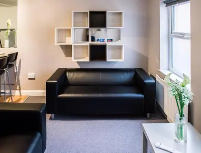 a black leather couch in a living room at Fishergate Apartments in Preston