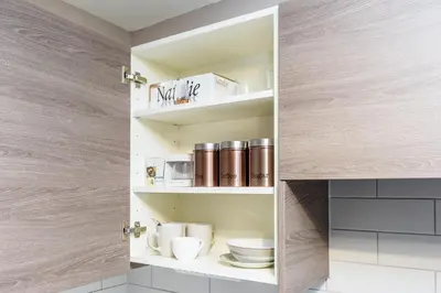 a cupboard with cups and plates on it at Fishergate Apartments in Preston