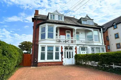 a large white house with a brick driveway at Fairhaven View Apartments - Lytham St Annes in Lytham St Annes