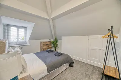 a bedroom with a bed and a window at Fairhaven View Apartments - Lytham St Annes in Lytham St Annes