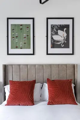 a bedroom with three framed pictures above a bed at Flatzy - City Centre Mansion 2, Sleeps 22, 4 Baths in Liverpool